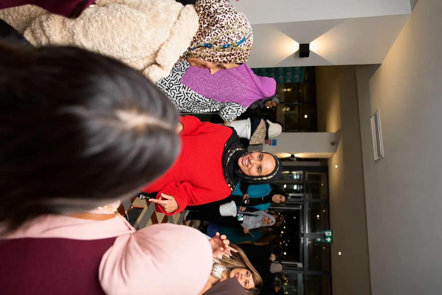 Fathiya Saleh chatting with a group behind the scenes